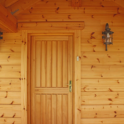 Mountain cottage entrance lighting with side hand wrought iron lamps