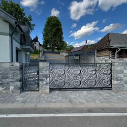 A sliding wrought iron gate at a family house in the Spiš region – made according to a design by architect Ing. Jozef Figlár A sliding wrought iron gate at a family house in the Spiš region – made according to a design by architect Ing. Jozef Figlár