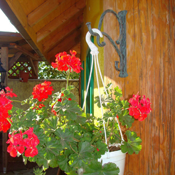 A forged flower pot holder in folk design