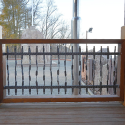 A wrought iron grille pattern - Crazy - in wooden frame on the stage in the pilgrimage place Butkov