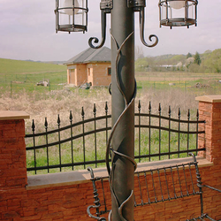 Wrought iron lights and benches in a garden Wrought iron lights and benches in a garden