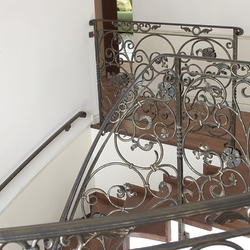Forged staircase railing and handle in the interior of afamily home  high quality railing