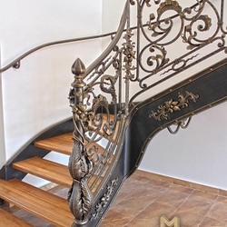 A wrought iron staircase with an exceptional interior railing