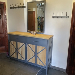 Forged furniture in the entrance hall of a family house - forged chest of drawers, hangers, mirror