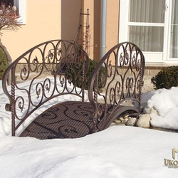 A wrought iron garden bridge