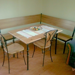 Corner dining bench, table and chairs in the apartment of the folk pension ari Park - wrought iron furniture 